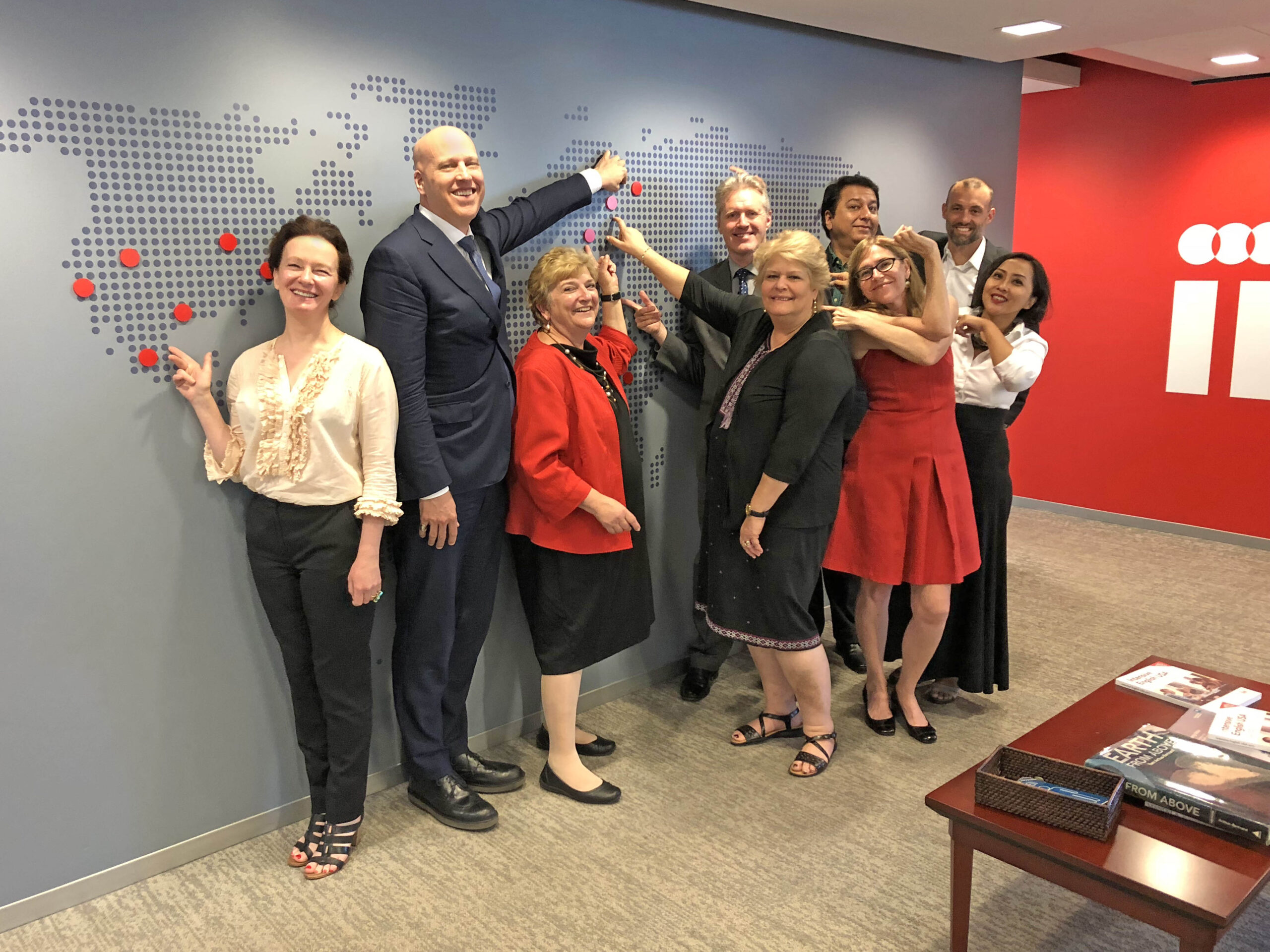 Heads of IIE International Offices Point at their Respective Offices on the Map